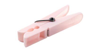A pastel pink clothespin with a metal spring, set against a black background