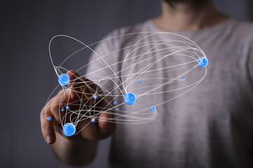 Abstract image of a hand interacting with a digital network, representing connection, technology,...