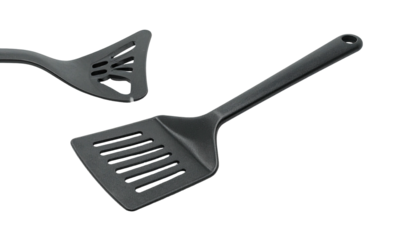 Two dark-colored kitchen utensils on a black background a spatula and a masher
