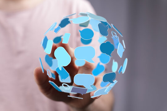 Conceptual image of a communication sphere above a hand, showcasing global connectivity and the importance of dialogue in the digital age.