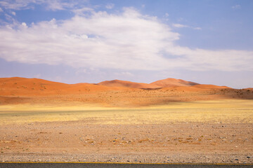 Sossusvlei in Namibia is a desert wonder, famous for its giant red dunes, glowing at sunrise and sunset