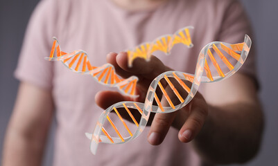 High-quality stock photo of a hand interacting with a DNA strand, perfect for medical, science, and...