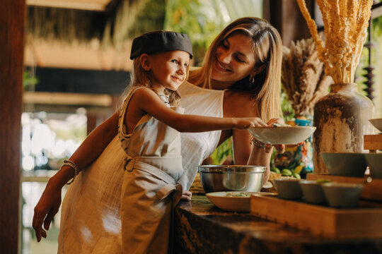 Mother and son cooking together in a warm and inviting kitchen