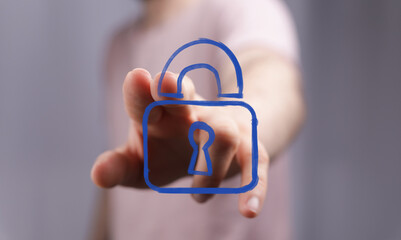 Image depicts a hand interacting with a digital padlock, symbolizing online security, data...