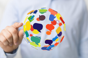 A floating globe comprised of colorful speech bubbles, symbolizing digital networking and global...