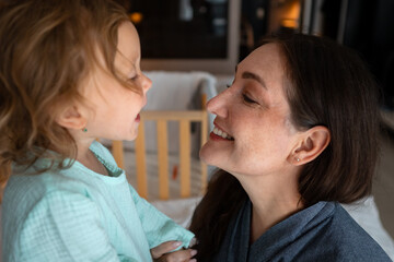 Mother and daughter sharing a tender moment at home