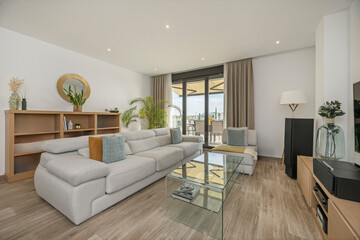 Open space with modular sofa, cement coffee table, and dining room with industrial-design chairs