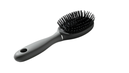 A gray oval-shaped hair brush with dark bristles, on a stark black background