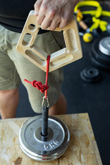 Close-up of a male hand gripping a wooden climbing edge with fingers during sport-specific exercise...