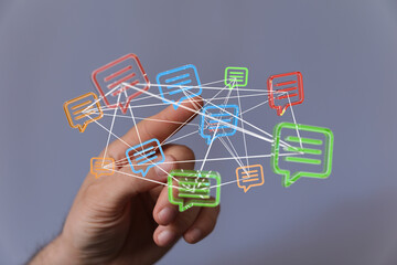 Innovative concept of digital communication and data transfer. Modern person using a network cloud of digital message bubbles representing commu