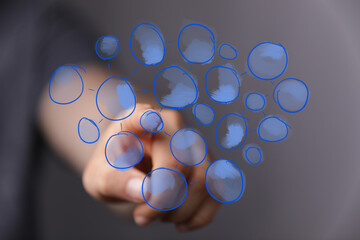 Dynamic conceptual image of a human hand interacting with a futuristic blue data network interface, symbolizing global connectivity, digital tra