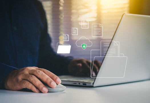 Secure cloud data storage concept, Businessman using laptop with digital folders and documents, illustrating online file management, cybersecurity, and safe digital document organization solutions