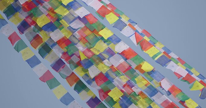 Boudhanath Stupa, Kathmandu, Nepal. Colorful Buddhist prayer flags shine under the sun and flow freely in the wind, symbolizing spiritual peace, calm vibration, and sacred cultural heritage