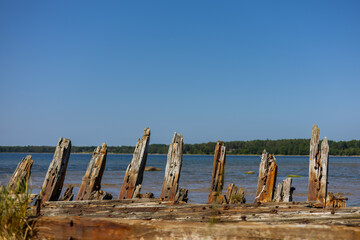 Close up photo of shipwreck of Raketa on the shore of Baltic Sea. Wooden wreck of the fork schooner...