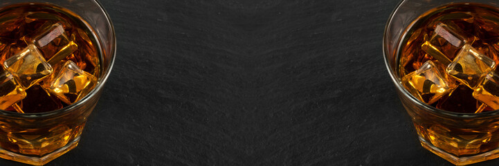 Iced Whiskey Glass on Natural Black Stone Background