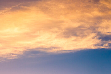orange cloud on blue sky at sunset. beautiful nature background at dusk for meteorology. cloudscape in yellow light. abstract scene of summer weather