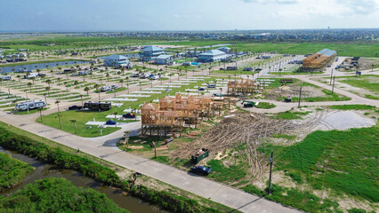 Manmade drainage canal, engineered waterway near build zone of wooden stilt houses in Crystal Beach, Bolivar Peninsula, Texas, designed for stormwater management in flood-prone coastal region