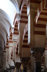 Cordoba, Spain 03.27.2019: Ceiling with double arches of white stone and red brick at the Prayer...
