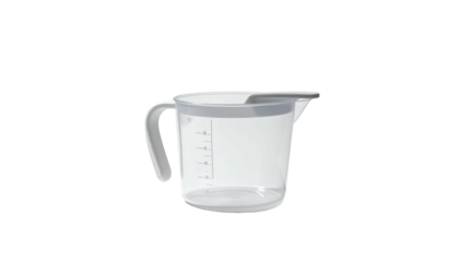 A translucent plastic measuring jug with grey accents and a handle, on a black background