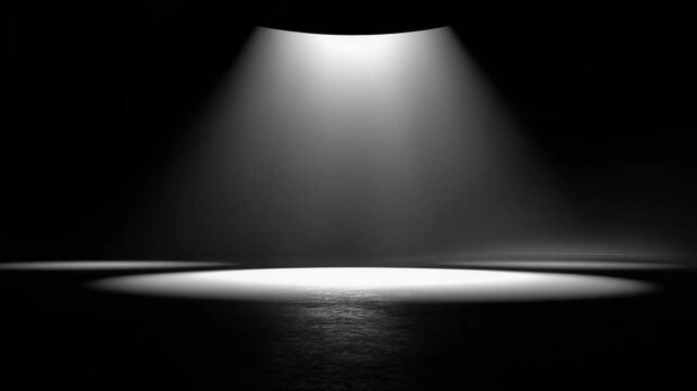 A single spotlight on a dark stage, illuminating a bright circular patch on the floor.