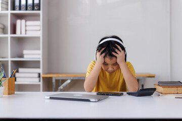 Asian student feeling stressed while studying online at home