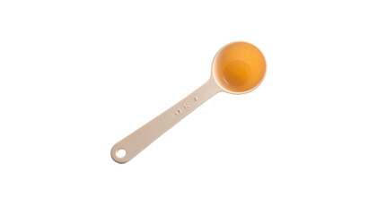 A measuring spoon is filled with amber liquid, placed diagonally against a black background