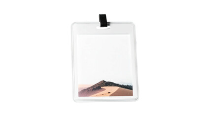 A rectangular badge with a landscape picture, attached to a clip, set against black