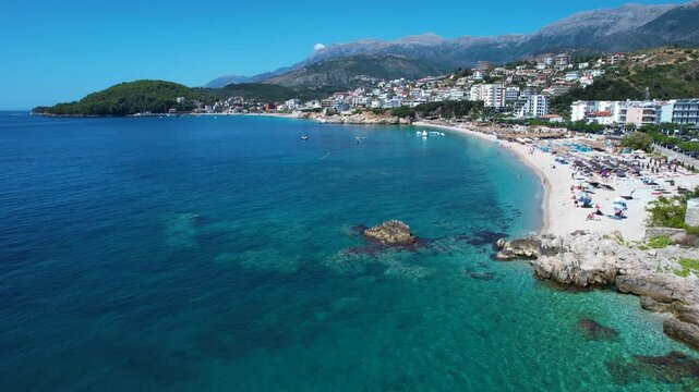 Tourists Enjoy Quiet Sunbathing at Himara Beach Resorts Facing the Sparkling Blue Ionian Sea