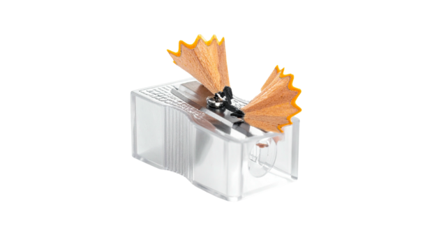 Clear plastic tool with shavings from sharpening a pencil on a black background - Powered by Adobe