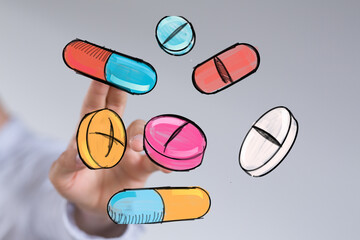 Hand holding colorful drawn pills and capsules. Healthcare, medicine, pharmacy concept.