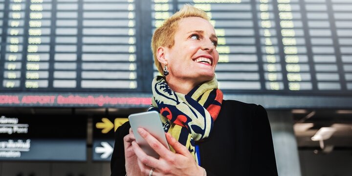 Traveler checking flight information screen