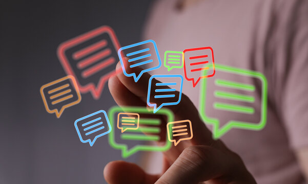 Finger hovering over colorful message bubbles. Concept for digital marketing and instant communication on touch screen interface.