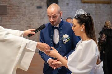 Elegant couple exchanging vows at the altar, surrounded by family and friends on their wedding day