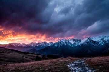 Fototapeta premium Majestic mountain range under dramatic sky at sunset