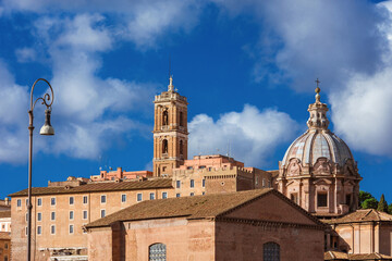 Rome beautiful historical center with Capitol bell tower, the Curia Julia ruins and baroque dome