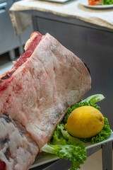 Fresh raw meat ready to be prepared by chefs in a professional restaurant kitchen setting