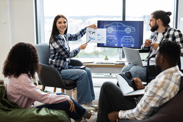 Team of diverse engineers and designers collaborate on futuristic car design project using digital displays and charts promoting innovation and teamwork