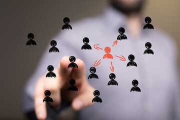 Image depicts a hand pointing to a central figure surrounded by a network of people, symbolizing...