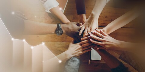 Hands joined over wooden table