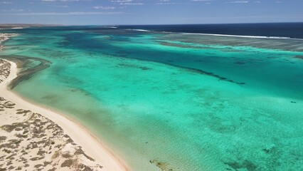Panoramic aerial view of Osprey Bay WA with boats, reef, and scenic shoreline under bright sunlight