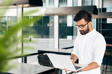 Indian man working on laptop