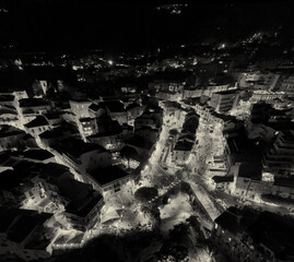 Aerial night view of Tropea town and coastline illuminated during summer from a drone