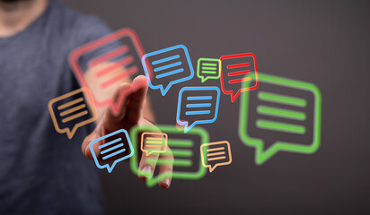 Concept of instant communication, messaging and connection depicted with speech bubbles and human hand reaching towards modern digital icons.