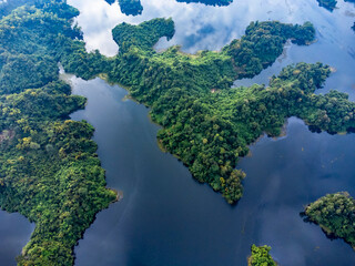 Mohamaya Lake is the second-largest artificial lake in Bangladesh, located in Mirsarai, Chittagong, Bangladesh. Aerial view of a tranquil lake with a pier and docked boats surrounded by lush greenery.