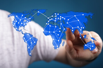 Hand interacting with a digital world map showing global network connections. Technology, communication, globalization concept.