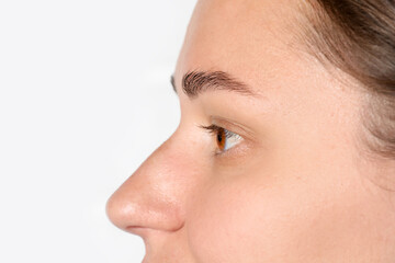 Woman with beautiful eyes on light background, closeup. Space for text