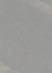 Close-up view of a textured gray surface with subtle cracks and faint markings