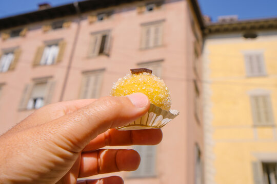 man holding a italian Polenta e Osei sweet