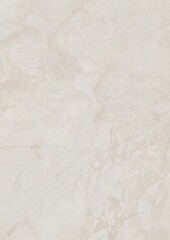 Close-up of a smooth, light-colored marble surface with subtle veining patterns.