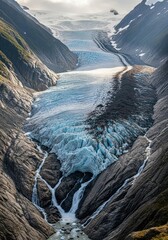 Majestic Glacier Carving Through Mountainous Terrain.